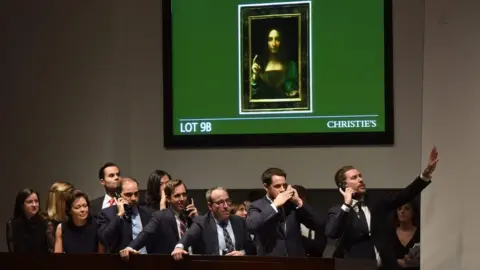 AFP Christie's employees take bids for Salvator Mundi in New York November 15, 2017