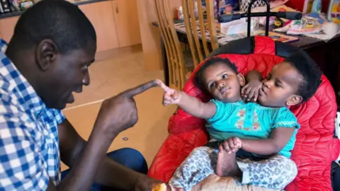 Glenn Edwards Ibrahima and his girls in early 2019 - when doctors were considering separation