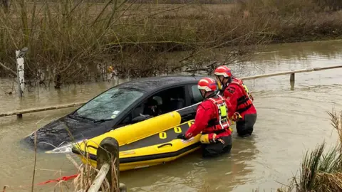 Firefighters and car in water at Buttsbury Wash