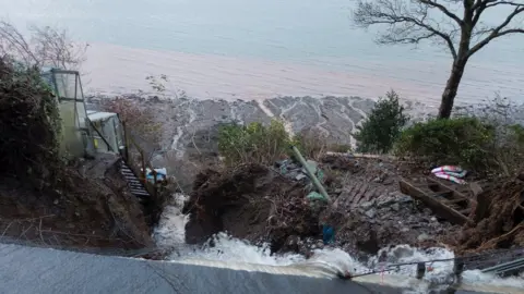 Facebook Flood water sweeping away land on the A545 between Menai Bridge and Beaumaris on Anglesey