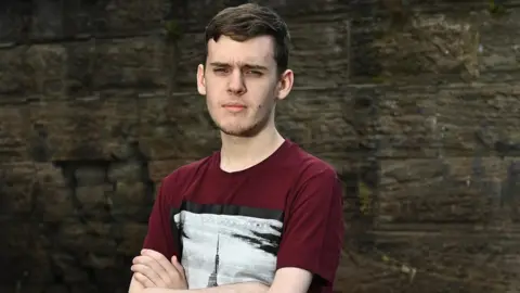 Equality Commission for NI Harvey Spence looking at the camera with his arms folded