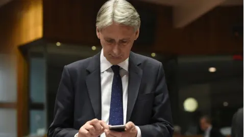 Getty Images Chancellor Philip Hammond on phone