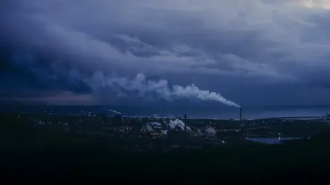 Roo Lewis A wide shot of Tata Steel in Port Talbot under a blue and moody sky
