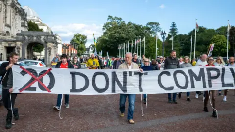 Getty Images People protest against the 20mph law change in Cardiff