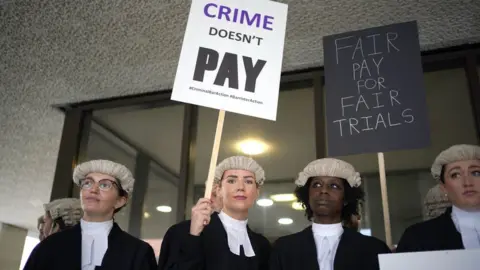 PA Media Criminal barristers from the Criminal Bar Association (CBA) demonstrating outside court