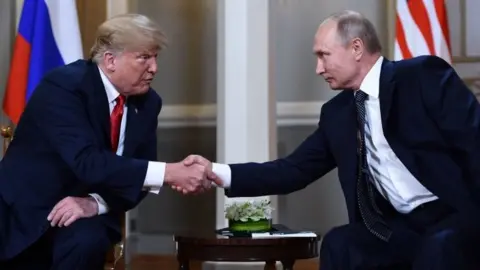 AFP Donald Trump and Vladimir Putin shake hands