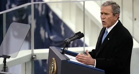 TIM SLOAN George W Bush at podium