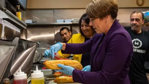 Getty Images Maura Healey visits Meridian Street Market and makes an Italian Sub as she campaigns on the eve of the US midterm election, in Boston, Massachusetts, on 7 November 2022