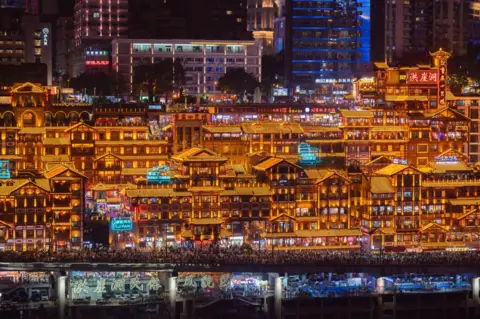 Getty Images Tourists visit the Hongya Cave scenic spot during the Mid-Autumn Festival and National Day holiday on September 30, 2023 in Chongqing, China.