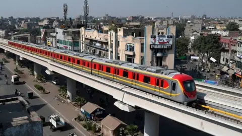Getty Images A train runs along the newly built Orange Line Metro in Lahore