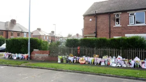 West Yorkshire Police Floral tributes outside house on Ash Crescent