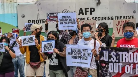 Getty Images US placards during a rally in front of the military headquarters in Quezon City, suburban Manila on February 2, 2023,