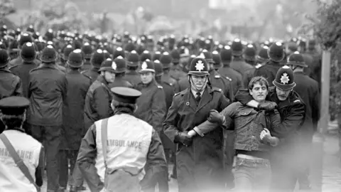 PA A sea of police helmets faced the pickets outside the Orgreave coking plant