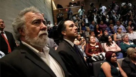 Reuters Deputy Secretary of Human Rights Alejandro Encinas Rodriguez (L) and Governor of Veracruz Cuitlahuac Garcia Jimenez (R), watch a screen in a public apology offered to relatives of five youths killed in 2016