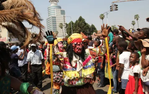 EPA A Malawi traditional dancer among other participants marches during the Harare International Carnival street parade in Harare, Zimbabwe, 09 September 2017. The carnival started on 01 September 2017 and a street party was held to officially open the carnival whose aim is to promote Zimbabwe as a safe tourist destination and to give local and foreign revellers the opportunity to interact with various cultures around the world.
