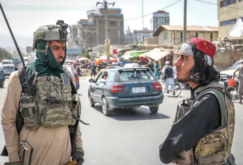 EPA Members of the Taliban stand in a checkpoint in Kabul, Afghanistan, 16 August 2021