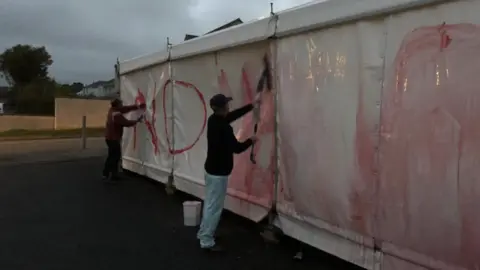 Mount Hawke Surgery Marquee with graffiti sprayed on it