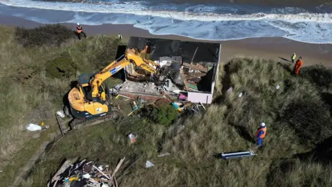 Martin Barber/BBC Sue's home being demolished