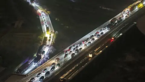 VCG Cars are stuck on a highway due to heavy snow in Wuhan, in central China's Hubei province