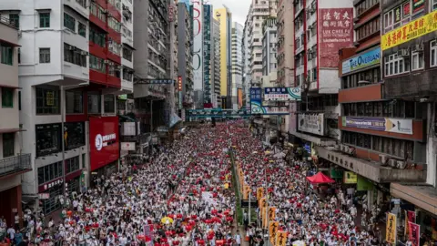 Getty Images Protestors march in the streets in Hong Kong in June