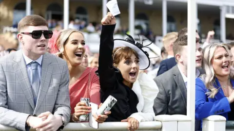 PA Media Woman celebrates win at Aintree