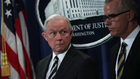 Getty Images Jeff Sessions (left) looks at Andrew McCabe during a July 2017 news conference