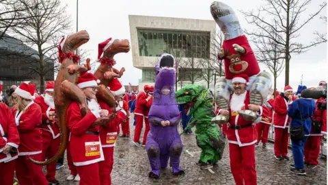 PA Media santas with dinosaurs outfit