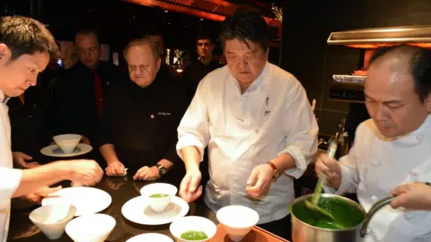 Getty Images French Chef Joel Robuchon (3rdR) and Japanese Chef Hirohisa Koyama (C) cook in the kitchen of the restaurant L'Atelier de Joel Robuchon, on 13 November 2012 in Paris