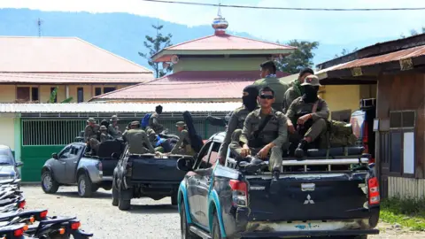 Getty Images Indonesian Mobile Brigade Police head to Nduga, where 31 construction workers are believed to have been shot dead, from Wamena on December 4, 2018