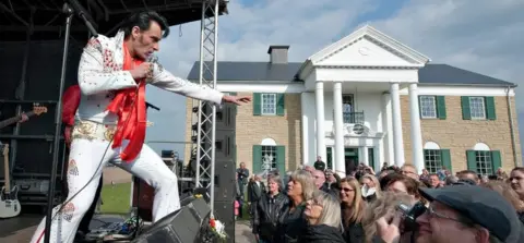 Getty Images An Elvis impersonator plays outside Memphis Mansions in Denmark