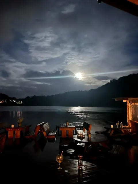 Flooded beer garden, river and moon