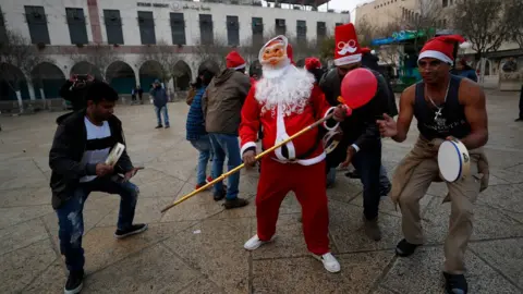 ATEF SAFADI/EPA-EFE/REX/Shutterstock Pilgrims from India celebrate at Manger Square, next to the Nativity Church