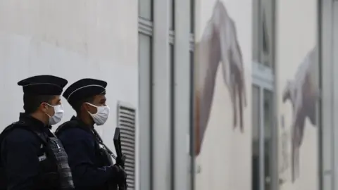 EPA Police stand guard outside the former offices of Charlie Hebdo in Paris on 26 September 2020