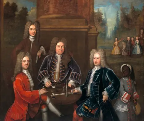 Getty Images An 18th Century British painting of Elihu Yale with the 2nd Duke of Devonshire, Lord James Cavendish, Mr Tunstal, and a Page or a slave by an unknown artist