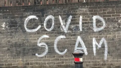 Covid scam graffiti