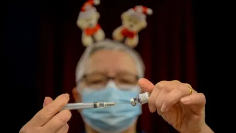 Getty Images Man preparing Covid vaccination