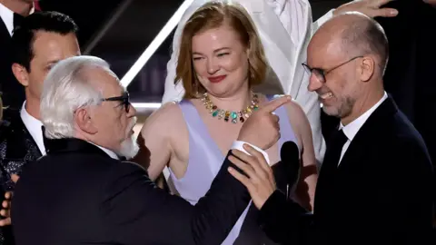 Getty Images Succession stars Jeremy Strong, Brian Cox and Sarah Snook with creator Jesse Armstrong (right) on stage at the Emmys