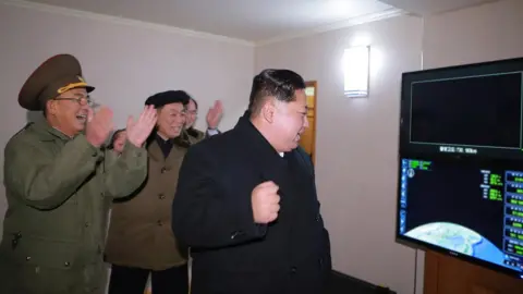 KCNA Kim Jong-un celebrates the launch of a Hwasong-15 missile