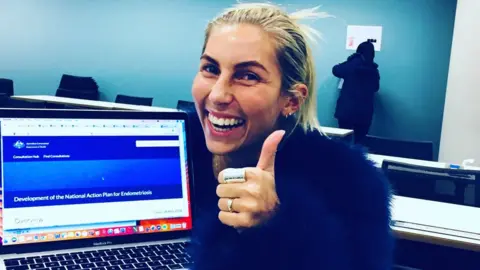 Syl Freedman Syl Freedman gives a thumbs-up gesture while seated in front of a computer, saying: "National Action Plan for Endometriosis"