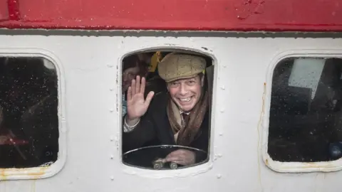 PA Media Nigel Farage on a crabbing boat in Grimsby
