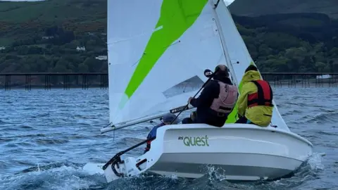 MANX LOTTERY TRUST A dinghy on the water