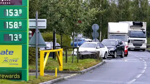 PA Media People queuing outside a petrol station in Wetherby, near Leeds