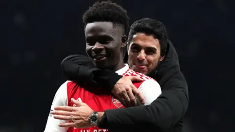 Arsenal forward Bukayo Saka and Gunners boss Mikel Arteta