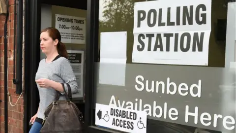 Getty Images Woman walking out of polling station