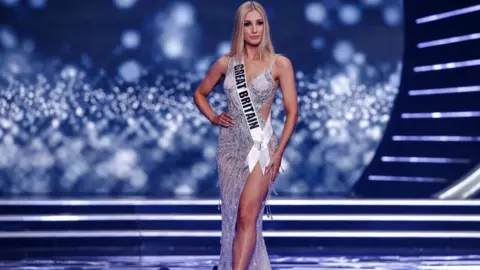 Menahem KAHANA/ AFP via Getty Images Miss Great Britain, Emma Collingridge on stage during the preliminary stage of the 70th Miss Universe pageant in Israel.