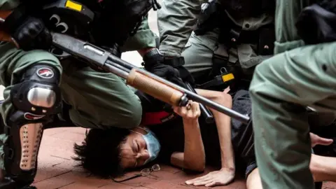 Getty Images Pro-democracy protesters are arrested by police in the Causeway Bay district of Hong Kong on May 24, 2020, ahead of planned protests against a proposal to enact new security legislation in Hong Kong.