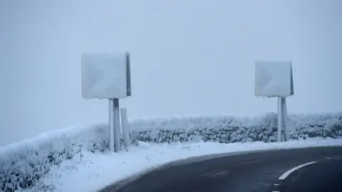 Getty Images Road signs are covered with snow on the A628 Woodhead Pass in the Longdendale Valley in Derbyshire's High Peak