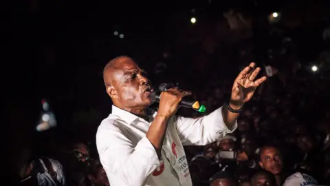 Getty/ALEXIS HUGUET Martin Fayulu, an opposition leader running for president, delivers a speech