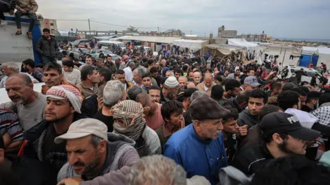 Getty Images UNRWA distributes flour to Palestinian families in the Al-Mawasi area