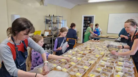 Volunteers preparing breakfast boxes